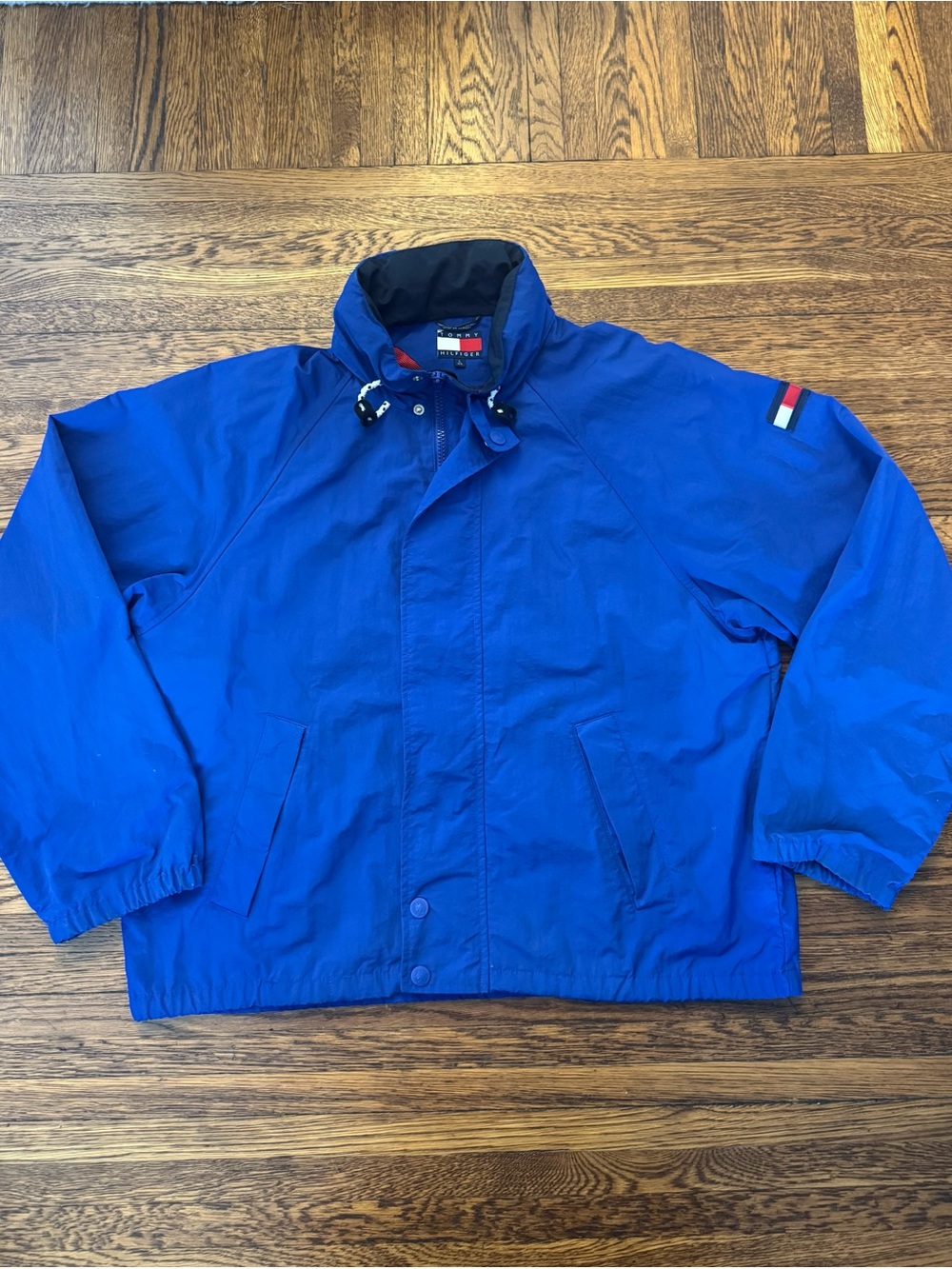 Tommy Hilfiger 1980s-1990s Blue Windbreaker Jacket with tucked away hoodie.